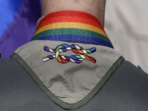 FILE - In this Sunday, June 8, 2014, file photo, a Boy Scout wears his kerchief embroidered with a rainbow knot during Salt Lake City’s annual gay pride parade. The Boy Scouts of America's top policy-making board planned a vote Monday, July 27, 2015, on ending its blanket ban on gay adult leaders while allowing church-sponsored Scout units to maintain the exclusion if that accorded with their faith. (AP Photo/Rick Bowmer, File)