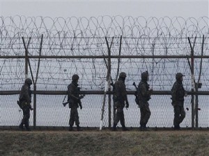 South Korean army soldiers patrol along a barbed-wire fence near the border village of the Panmunjom, in Paju, South Korea, Monday, April 8, 2013. North Korea said Monday it will recall 51,000 North Korean workers and suspend operations at a factory complex it has jointly run with South Korea, moving closer to severing its last economic link with its rival as tensions escalate. (AP Photo/Ahn Yong-joon)