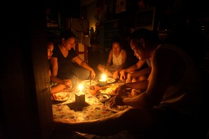 June 16, 2014 Black Out-the Molanida Family of Bgy. 101 in Vitas Tondo had their dinner in the dark during a massive black out in the Metro, after Typhoon Glenda's powerful winds on Wednesday, July 16 INQUIRER/ MARIANNE BERMUDEZ