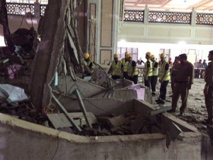 In this image released by the Saudi Interior Ministrys General Directorate of Civil Defense, Civil Defense personnel inspect the damage at the Grand Mosque in Mecca after a crane collapsed killing dozens, Friday, Sept. 11, 2015. The accident happened as pilgrims from around the world converged on the city, Islam's holiest site, for the annual Hajj pilgrimage, which takes place this month. (Saudi Interior Ministry General Directorate of Civil Defense via AP)