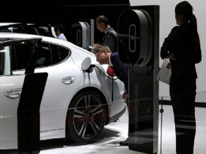 A visitor looks at Porsche Panamera S e-hybrid during the media preview of the Tokyo Motor Show in Tokyo Wednesday, Oct. 28, 2015. The biennial exhibition of vehicles in Japan runs for the public from Friday, Oct. 30. (AP Photo/Shuji Kajiyama)