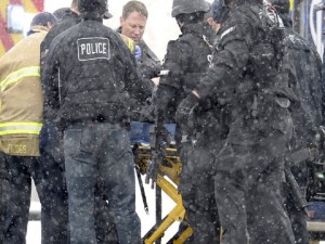 Emergency personnel transport an injured officer near a Planned Parenthood clinic Friday, Nov. 27, 2015, in Colorado Springs, Colo. A gunman opened fire at the clinic on Friday, authorities said, wounding multiple people. (Andy Cross/The Denver Post via AP) MAGS OUT; TV OUT; INTERNET OUT; NO SALES; NEW YORK POST OUT; NEW YORK DAILY NEWS OUT; MANDATORY CREDIT