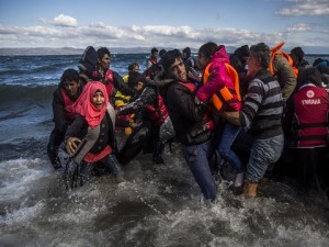 Afghan migrants disembark safely from their frail boat in bad weather on the Greek island of Lesbos after crossing the Aegean see from Turkey, Wednesday, Oct. 28, 2015. Greece’s government says it is preparing a rent-assistance program to cope with a growing number of refugees, who face the oncoming winter and mounting resistance in Europe. (AP Photo/Santi Palacios)