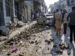 RAWALPINDI, PAKISTAN - OCTOBER 26: Debris of buildings and panicked Pakistani residents are seen in the streets following a massive earthquake in Rawalpindi, Pakistan, on October 26, 2015. At least 17 killed in Pakistan after 7.5 magnitude quake rocks South Asia. (Photo by Muhammad Reza/Anadolu Agency/Getty Images)