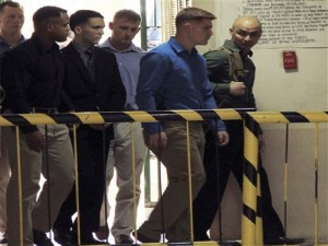 U.S. Marine Pfc. Joseph Scott Pemberton, third left, the suspect in the Oct.11, 2014 killing of Filipino transgender Jennifer Laude at the former U.S. naval base of Subic, northwest of Manila, is escorted into the courtroom for his scheduled trial Monday, March 23, 2015 at Olongapo city, Zambales province, northwest of Manila, Philippines. Pemberton was tagged as the suspect in the killing which the protesters termed as a "hate crime" against LGBT (Lesbian, Gay, Bisexual and Transgender) Filipinos. (AP Photo/Jun Dumaguing)
