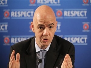 FILE - In this Feb. 22, 2014 fiel photo UEFA General Secretary Gianni Infantino gestures during a press conference, one day prior to the UEFA EURO 2016 qualifying draw in Nice, southeastern France. Infantino used his manifesto, which was published Tuesday, Jan. 19, 2016, to say FIFA should not limit the tournament to be being held in one or two countries. (AP Photo/Lionel Cironneau, file)