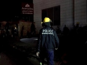 A police officer walks towards the scene of a fire in a hotel and adjacent massage parlor which has killed several people and injured others Frida, Feb. 5, 2016, in Irbil, capital of the Kurdistan region of Iraq. Nawzad Hadi, the governor of Irbil, said the fire broke out in the sauna of the Hotel Capitol at 4pm on Friday afternoon. He said that 15 of the victims were identified as from the Philippines, three were Iraqis and one was Palestinian. (AP Photo/Bram Janssen)