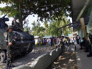 Philippine soldiers guard a school building serving as a polling station during the village-level election in the village of Salbu, Datu Saudi Ampatuan town, Maguindanao province, in the Philippines southern island of Mindanao on October 25, 2010. Gunmen assassinated two people on October 25 as violence, delays and irregularities marred Philippine elections to choose thousands of village and district officials, police and authorities said. A hand grenade was also thrown in front of a polling precinct in the restive southern province of Maguindanao hours before voting began, forcing poll officials to cancel elections there.   AFP PHOTO/Mark Navales