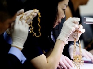 Christie's auction house appraisers examine a set of jewelry from Roumeliotes Collection, one of three sets of the Marcos Jewelry Collection, during appraisal at the Central Bank of the Philippines Tuesday, Nov. 24, 2015 in Manila, Philippines. The Philippine government is having millions of dollars’ worth of jewelry seized from former first lady Imelda Marcos appraised Tuesday ahead of a possible auctioning of the collection. The jewelry was seized when Marcos’ family fled to Hawaii in 1986 following a revolt that ended her husband’s two decades in power. (AP Photo/Bullit Marquez)