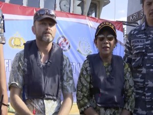 In this image made from video, Stig Traavik, left, Norwegian Ambassador to Indonesia, left, and Susi Pudjiastuti, Indonesia Maritime and Fisheries Minister, speak before illegal fishing vessel Viking, which was seized by Indonesias Navy, is sunk with explosives in the waters off Pangandaran, West Java, Indonesia, Monday, March 14, 2016. Indonesian authorities used explosives to sink the last major sought-after illegal fishing vessel on Monday after it had evaded international authorities for years, reiterating a strong message to would-be poachers that enter the country's waters. (AP Photo/APTN)