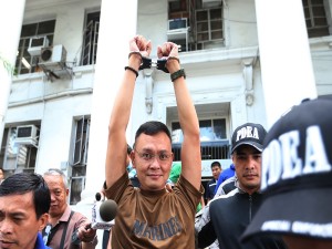 FEBRUARY 10, 2016 Lt. Col. Ferdinand Marcelino raises his hands as he lleaves DOJ building after attending the preliminary hearing at the office of Senior Deputy State Prosecutor Theodore Villanueva at the Department of Justice in Manila. Marcelino  is an active Marine officer of the Philippine Navy, graduate of the Philippine Military Academy Bantay Laya Class of 1994. He is now facing a tough battle for his career and security when he got arrested together with a Chinese citizen and former PDEA interpreter Yan Yi Shou in a raid conducted by the Philippine National Police (PNP) Anti-Illegal Drugs Special Operations Task Force and the PDEA in Celadon Place apartment building in Sta. Cruz, Manila on January 21, 2016. Marcelino and Yi Shou will face charges without bail in connection with the illegal drugs manufacturing and possession. EDWIN BACASMAS