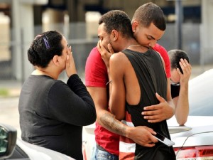 Friends and family members embrace outside the Orlando Police Headquarters during the investigation of a shooting at the Pulse night club, where as many as 20 people have been injured after a gunman opened fire, in Orlando, Florida, U.S June 12, 2016.  REUTERS/Steve Nesius     TPX IMAGES OF THE DAY