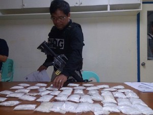 Operatives of the Criminal Investigation and Detection Group Central Visayas CIDG-7) checks on the P15 million drug haul seized in Barangay Lamintak Norte, Medellin town on Thursday morning (CDN PHOTO JUNJIE MENDOZA)