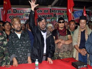 In this photo taken on August 12, 2013, Moro National Liberation Front (MNLF) leader Nur Misuari (C) addresses his armed followers in one of their camps in Indanan, Sulu, on the southern island of Mindanao, following his declaration that he was breaking away from the government because he believed they were sidelining his group. Followers of Misuari entered the coastal area of Zamboanga city by boat at dawn on September 9, triggering clashes that left at least one soldier dead and six wounded, the military said.    AFP PHOTO