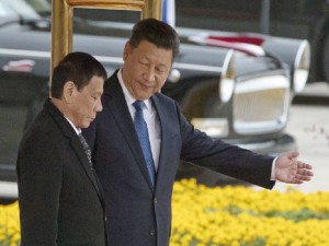 Chinese President Xi Jinping, right, shows the way to Philippine President Rodrigo Duterte during a welcome ceremony outside the Great Hall of the People in Beijing, China, Thursday, Oct. 20, 2016. (AP Photo/Ng Han Guan)