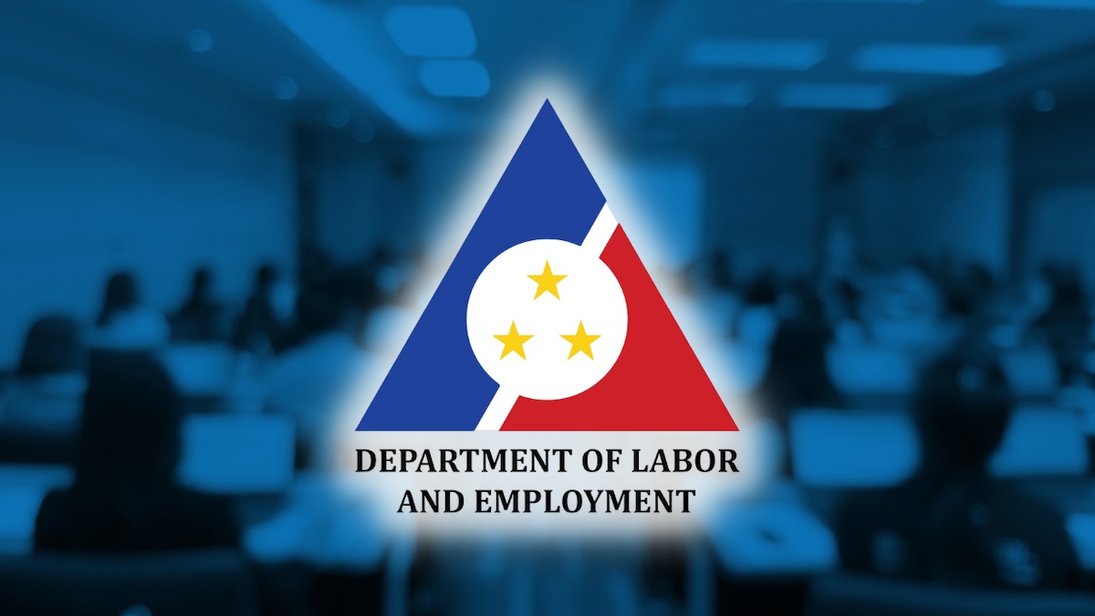 PHOTO: DOLE logo over an auditorium STORY: Metro Manila workers may dagdág na P35 sa daily minimum wage